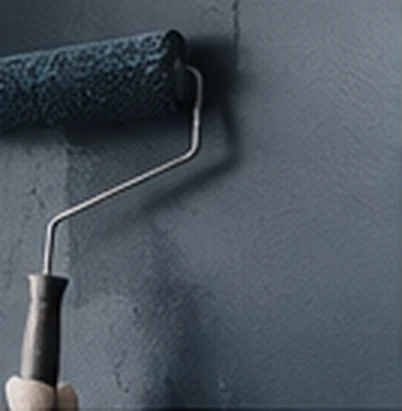 Roller applying dark paint to an interior wall